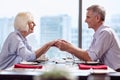 Cheerful mature couple grabbing their hands Royalty Free Stock Photo