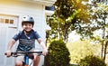 Let me show you some of my awesome biking skills. a young boy riding his bicycle through his neighbourhood. Royalty Free Stock Photo