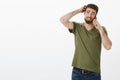 Let me think. Cute man with beard making plans as talking to friend via smartphone being unsure thinking as picking date Royalty Free Stock Photo