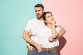 Let me think. Doubtful pensive couple with thoughtful expression making choice against pink background Royalty Free Stock Photo