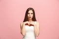 Let me think. Doubtful pensive woman with thoughtful expression making choice against pink background