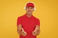 Let music speak. Happy man give thumbs ups yellow background. Enjoying favorite music. Handsome guy wear headphones