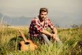 Let the Music Speak. hipster fashion. western camping and hiking. happy and free. cowboy man with acoustic guitar player