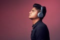 Let music take control. Studio shot of a handsome young man wearing headphones. Royalty Free Stock Photo