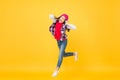 Let the music take you away. Energetic girl move to music. Little kid enjoy singing yellow background. Headphones