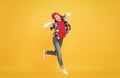 Let the music take you away. Energetic girl move to music. Little kid enjoy singing yellow background. Headphones