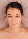 Let the pampering being. A beautiful young woman relaxing on a massage table before her massage. Royalty Free Stock Photo