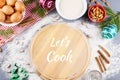 Let`s cook text with cutting coard, rolling pin, ingredients in background Royalty Free Stock Photo