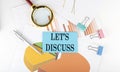 LET`S DISCUSS text on the sticker on the paper diagram Royalty Free Stock Photo