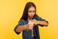 Let`s fight! Portrait of confident courageous girl in denim shirt keeping fists clenched, boxing and punching at camera Royalty Free Stock Photo