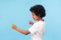 Let`s fight! Profile of aggressive little boy with curls in T-shirt holding clenched fists up Royalty Free Stock Photo