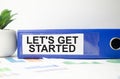 LET'S GET STARTED text concept write on file folder with office tools Royalty Free Stock Photo