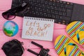 Let`s go to the beach on notebook with woman`s traveler accessories. Royalty Free Stock Photo