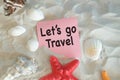 Let\'s Go Travel word on Paper is written on the beach sand Royalty Free Stock Photo