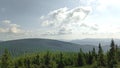 Let\'s go up the mountain. Landscape with clouds, pine trees and green grass. Journey through forests Royalty Free Stock Photo