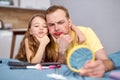 let's look at result. young father and child girl look at reflection on small mirror having facial make-up