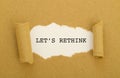 LET`S RETHINK word written under torn paper. Royalty Free Stock Photo