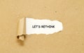 LET`S RETHINK word written under torn paper. Royalty Free Stock Photo