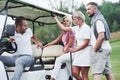 Let`s take a ride. Sitting to the golf cart after the game Royalty Free Stock Photo