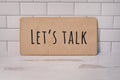 Let`s talk message written on wooden board rustic background