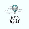 Let`s travel lettering with hot air balloon in clouds on a background of mountains. Travel concept.
