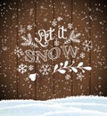 Let it snow, lettering on brown wooden background