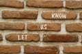 Let us know symbol. Concept words Let us know on brick wall. Beautiful brick wall background. Business and let us know concept.