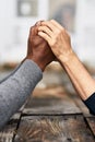 Let us pray. an unrecognizable senior couple holding hands in prayer while sitting outside. Royalty Free Stock Photo