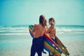 Let the waves take you away. a young couple walking on the beach with their surfboards. Royalty Free Stock Photo