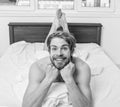 Let your body feel comfortable. Man unshaven handsome happy smiling torso relaxing bed. Guy macho lay white Royalty Free Stock Photo