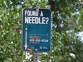 A Sign with the text Found a Needle at a playground