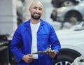 Lets assess your vehicle. Cropped portrait of a handsome young male mechanic working on the engine of a car during a