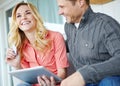 Lets buy it. a happy mature couple using a digital tablet to shop online together at home. Royalty Free Stock Photo