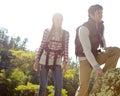 Lets climb up here. A happy young couple hiking through nature together. Royalty Free Stock Photo