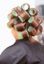 Lets cut. Rear view of a woman with rollers in her hair at the hairdresser. Royalty Free Stock Photo