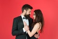 Lets dance tonight. Elegant couple in love tender hug dancing red background. Happy together. Man in tuxedo and woman Royalty Free Stock Photo