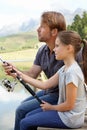 Lets fish together. a father and daughter holding a fishing rod. Royalty Free Stock Photo