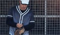 Lets get the ball rolling. a young man putting on his mitt at a baseball game. Royalty Free Stock Photo