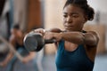 Lets get lifting. an attractive and athletic young woman working out with a kettle bell in the gym. Royalty Free Stock Photo