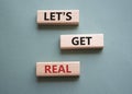 Lets get real symbol. Concept words Lets get real on wooden blocks. Beautiful grey green background. Business and Lets get real