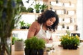 Lets get this written down. an attractive young female botanist making notes while working in her florist.