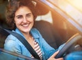 Lets go for a drive. Portrait of a happy young woman driving a car. Royalty Free Stock Photo