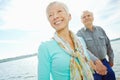 Lets go, honey. An attractive senior woman holding her husbands hand and leading him along the jetty. Royalty Free Stock Photo