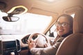 Lets go and make a success of the day. Portrait of a young businesswoman driving a car.