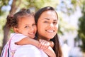 Lets go play mom. Shot of a mother giving her daughter a piggyback ride in the park. Royalty Free Stock Photo