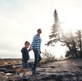 Lets go see the sunset. a cheerful mother and son holding hands while walking outside in nature during the day. Royalty Free Stock Photo