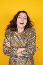 Lets go shopping. Young attractive woman with curly hair on yellow background. Festive sales concept