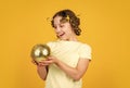 lets have fun on retro party. disco ball decoration. lovely girl with disco ball. Fashion girl pose in curlers on yellow Royalty Free Stock Photo