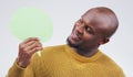 Lets have a look at what theyre saying about me. a handsome young man holding a speech bubble against a grey background. Royalty Free Stock Photo