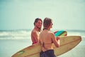 Lets hit the waves. a young couple walking on the beach with their surfboards. Royalty Free Stock Photo